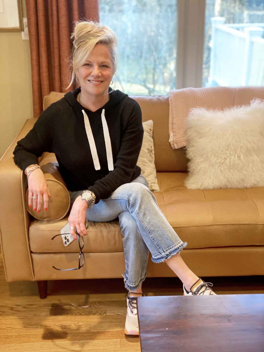 Colleen Van Houten interior designer sitting on couch about page